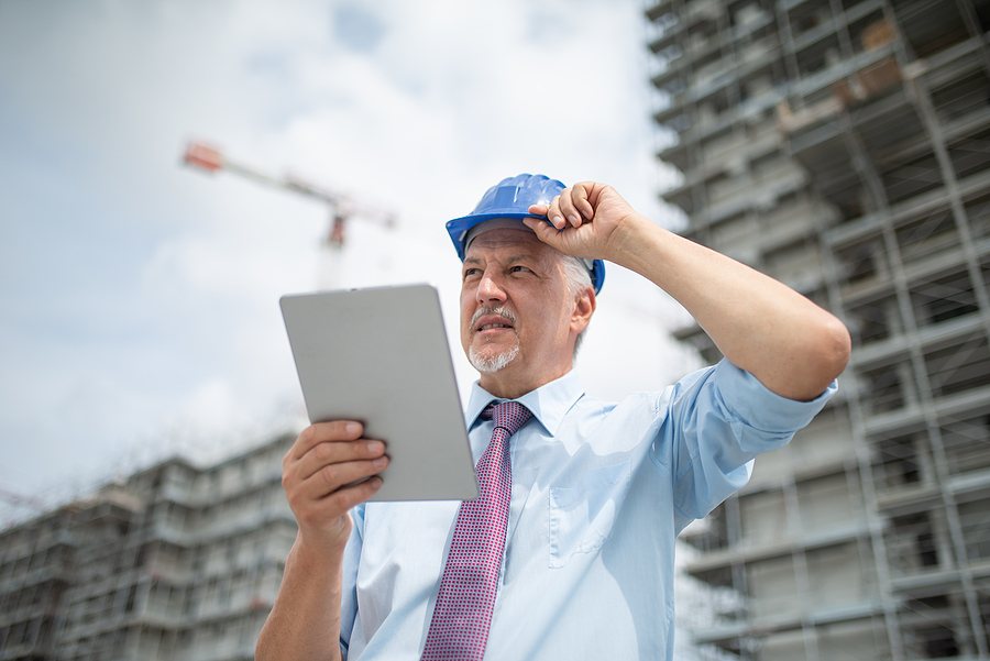 Architect using a site diary installed in his tablet